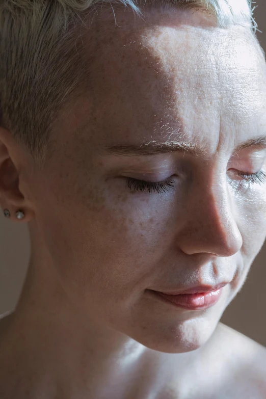 a woman with blond hair is in profile while looking down