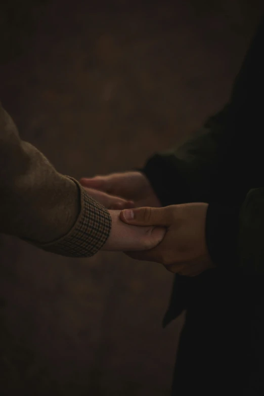 a couple holding hands next to each other
