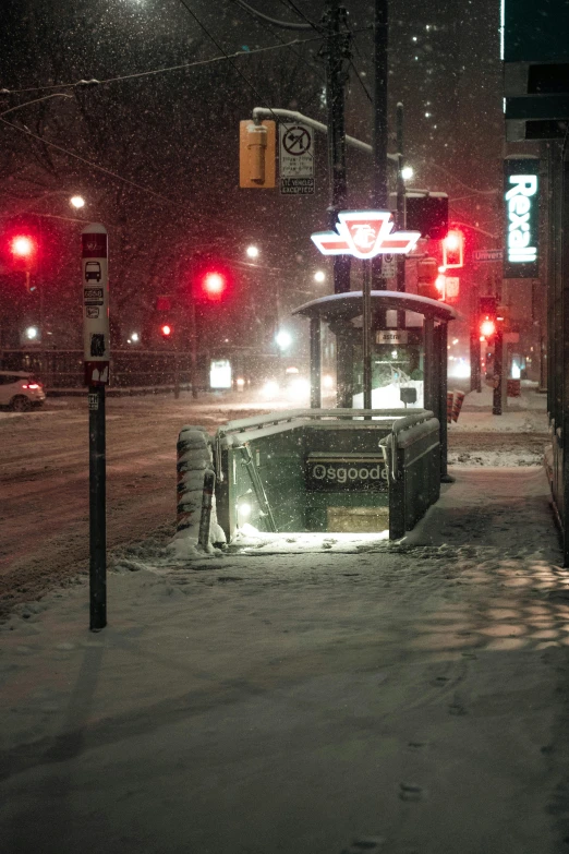 street signs and a snow covered stop light