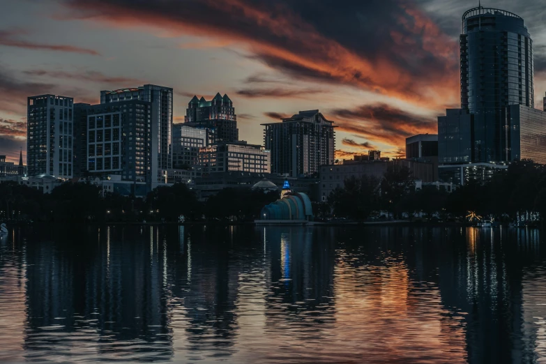 a sunset in the city with skyscrs in the background