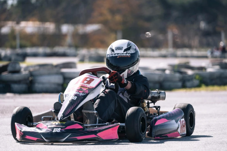 an older man is riding a go kart on the street