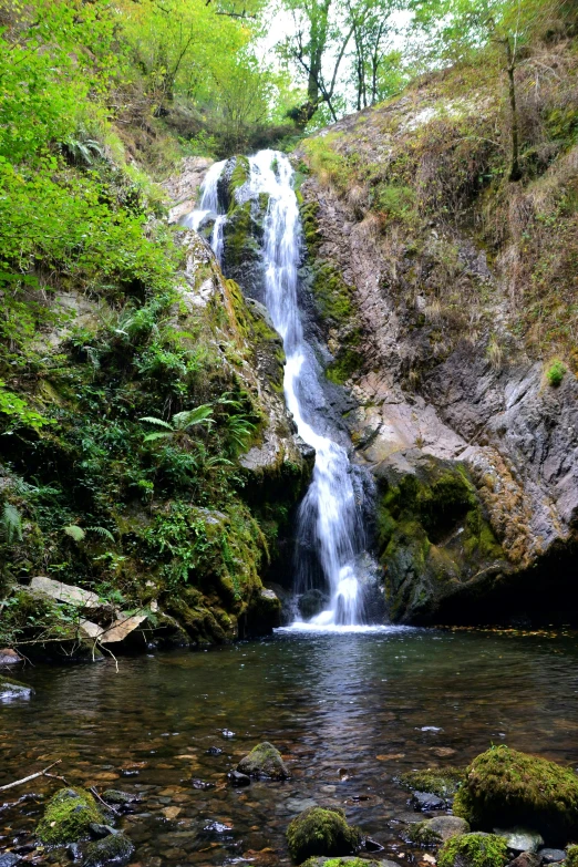 a beautiful waterfall with lots of water coming from it