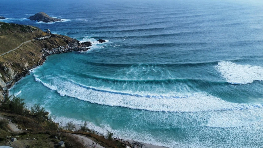 an aerial view of the ocean and beach from a mountain