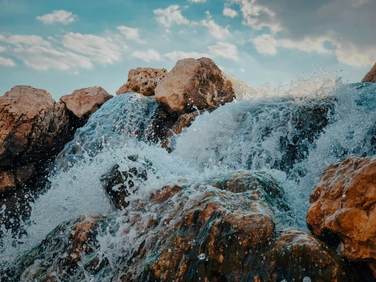 water splashing from a large rocky cliff