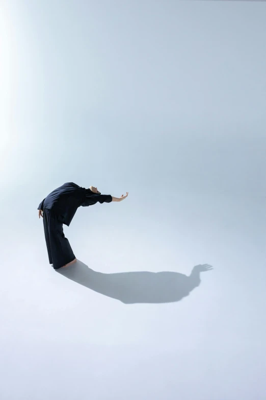 a person in black suit standing on the ground