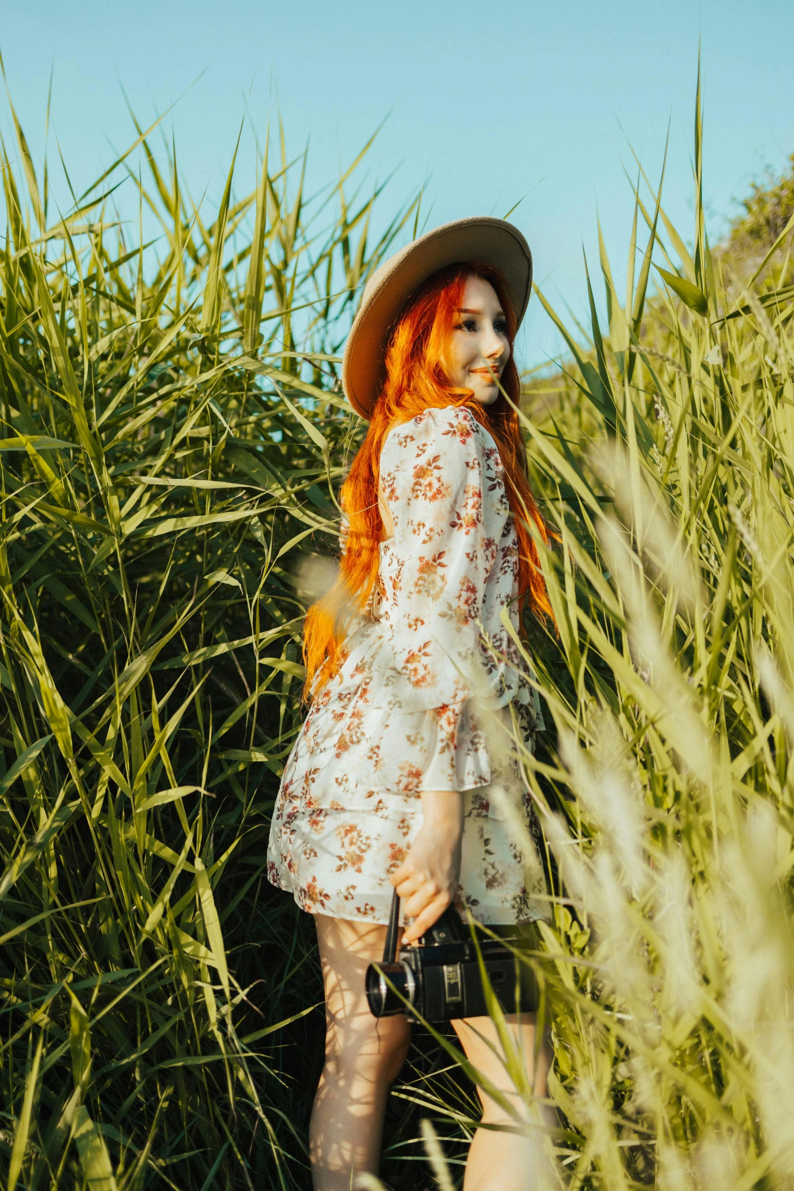 a woman standing in the middle of tall grass