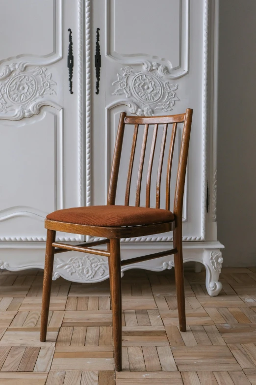 a chair and a wall unit in an empty room