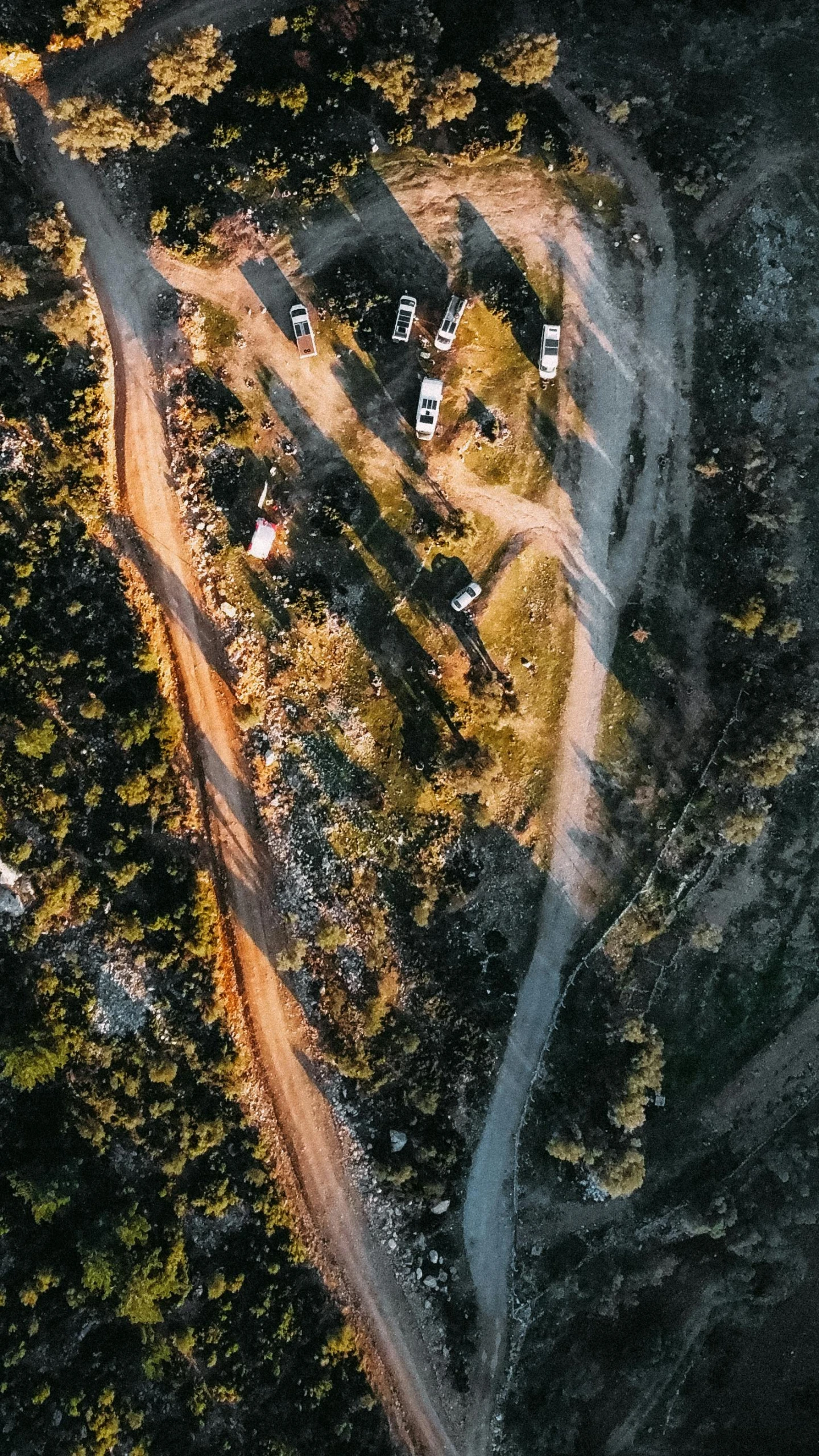 an aerial view of a road and houses in a valley