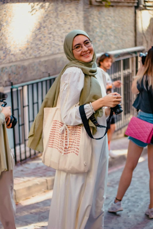 a woman with a green scarf is walking