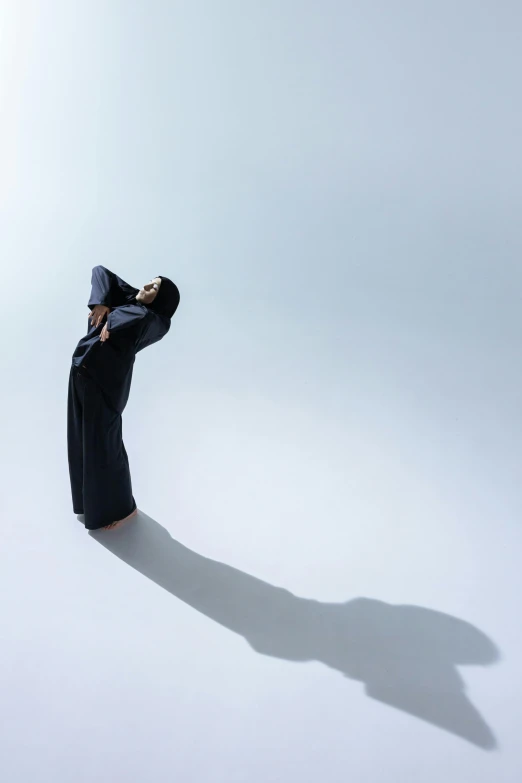 a man is looking at the sky with his hat on