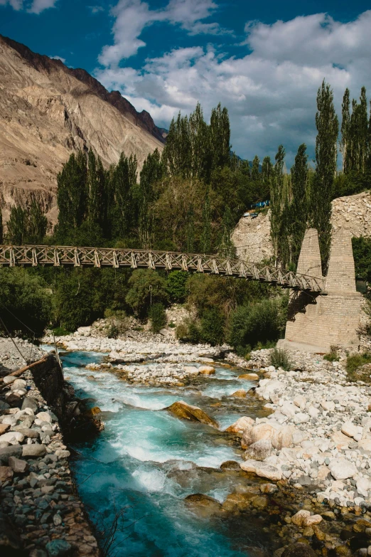 a bridge over a creek is surrounded by water