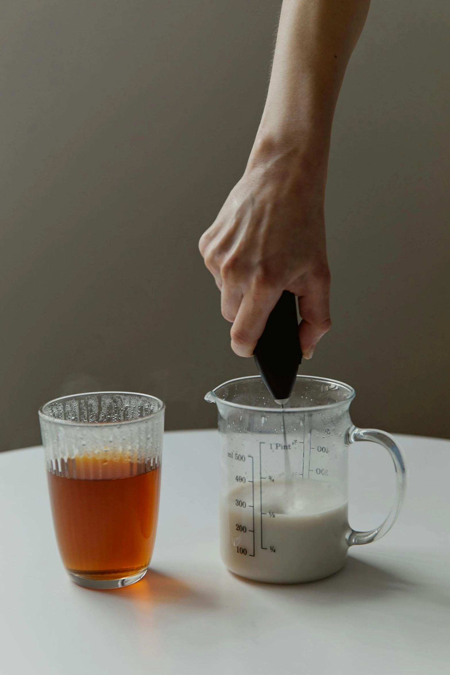 a person is hand measuring soing with a shaker