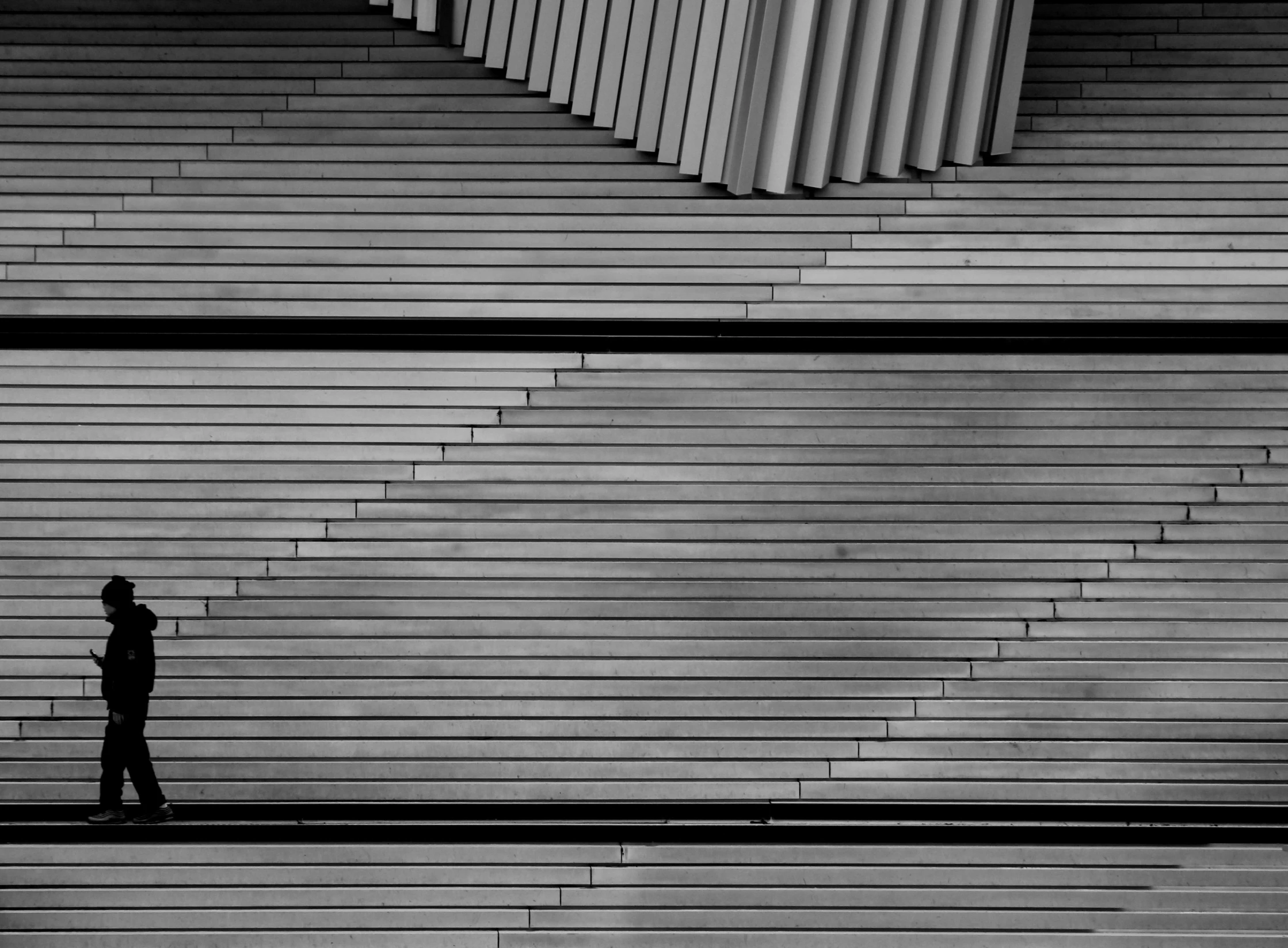 a lone man walks on a set of steps