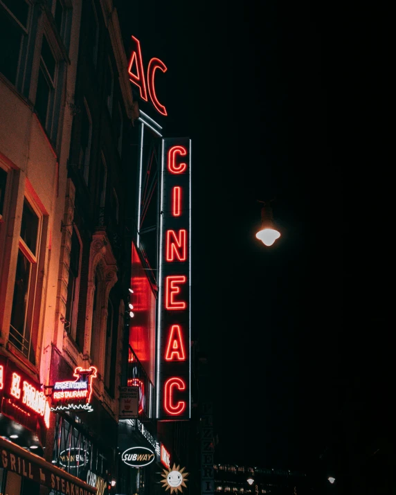 an old theater is lit up at night