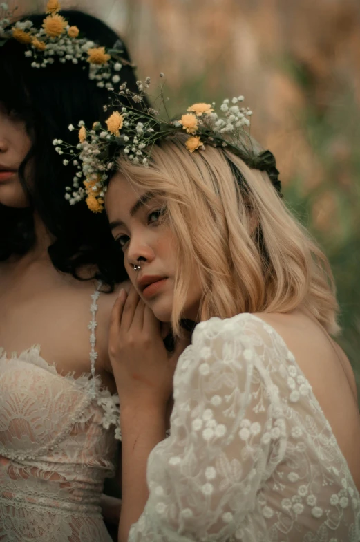 a close up of two girls wearing flowers