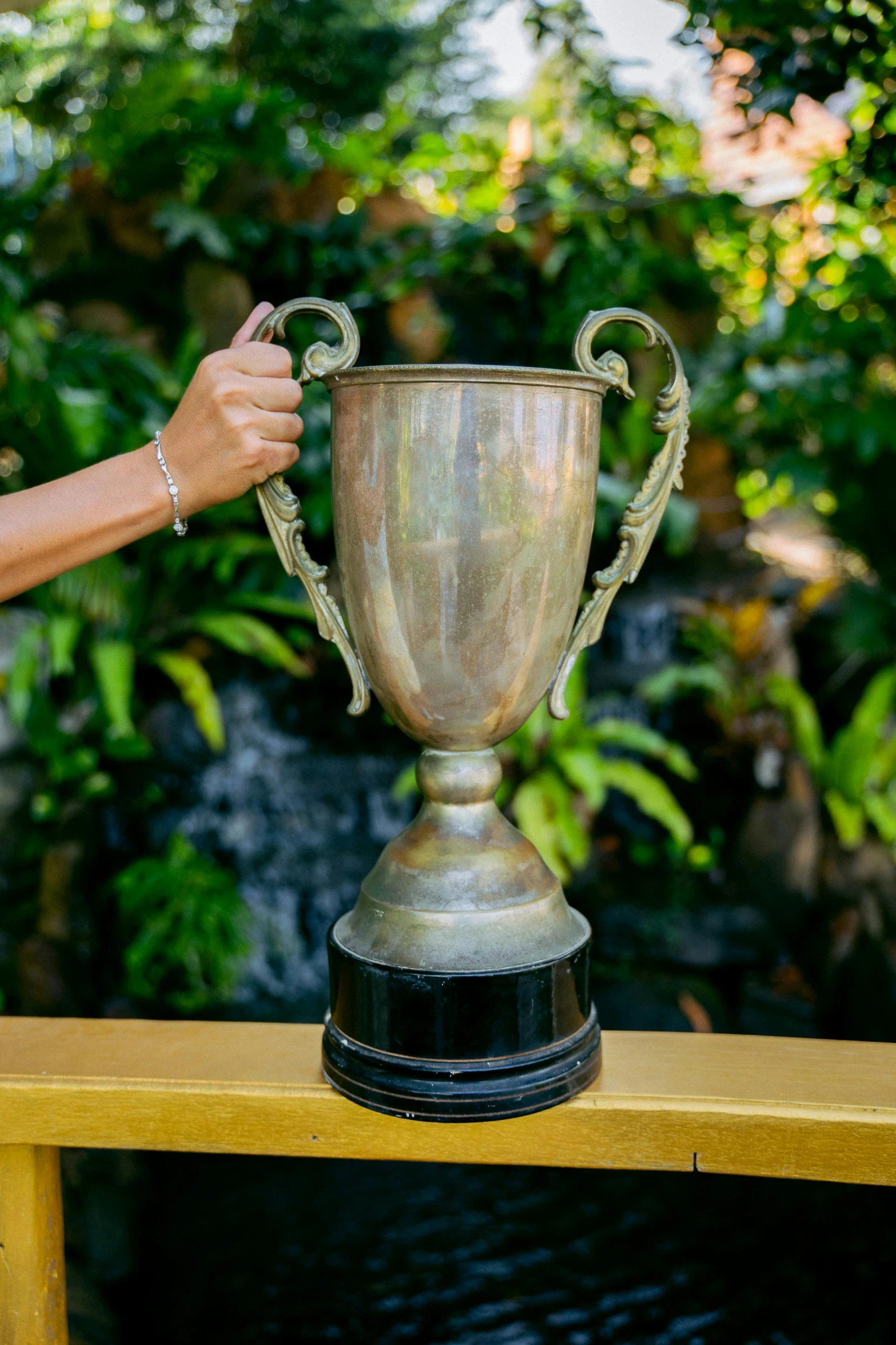 the woman is holding up a trophy in her hand