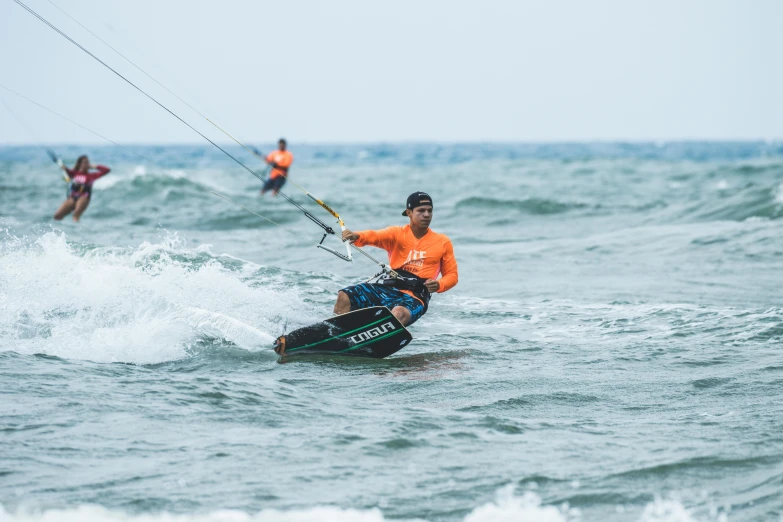 a man riding a board while holding a para sail