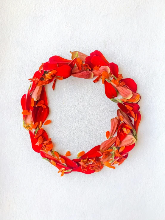 a wreath made of flowers on a white table