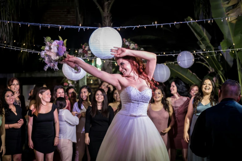 bride spinning a white paper ball with her hand