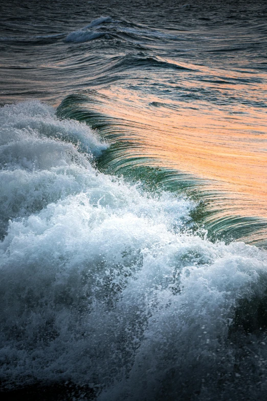 a person riding on a surfboard on a wave