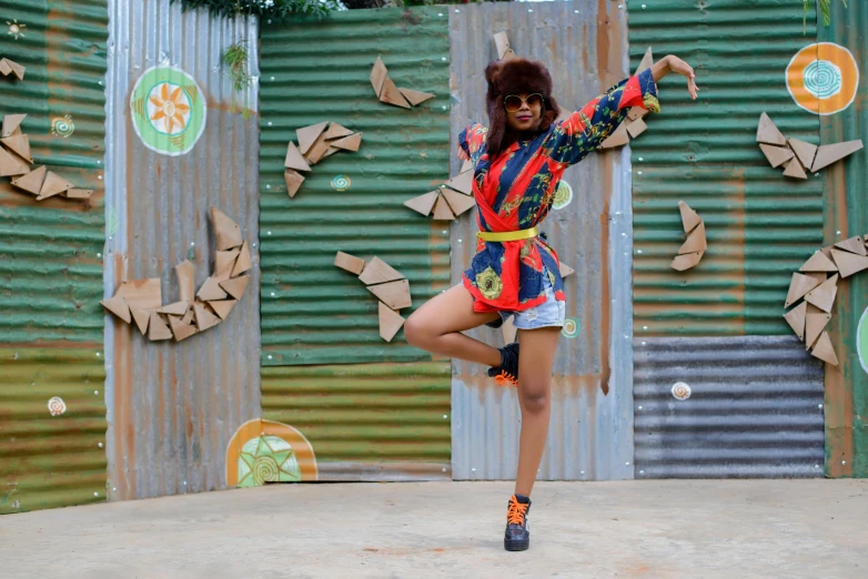 a woman wearing an animal print dress and boots