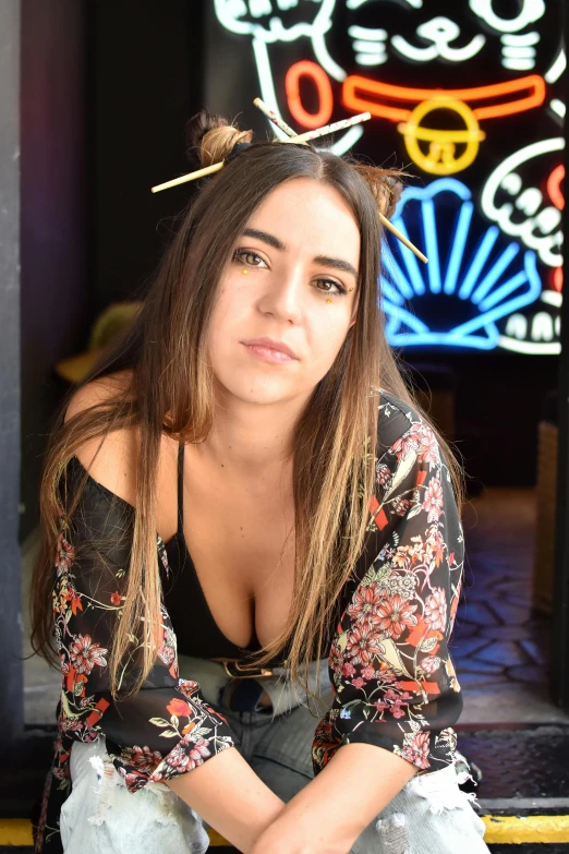 woman in a black top with an umbrella in the background