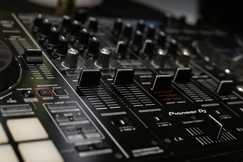 an electronic sound mixing board in a dark room