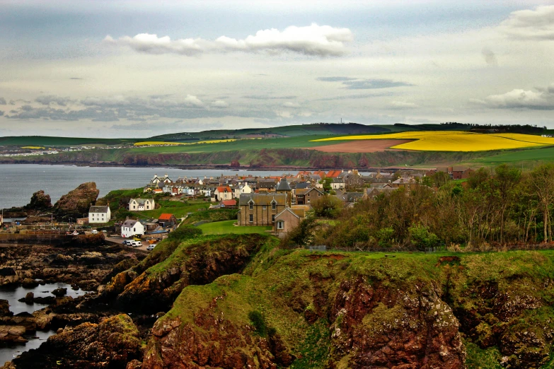 several houses that are on the land by the water