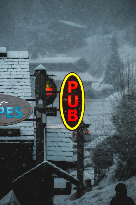 the sign for pub pees is shown in the snow