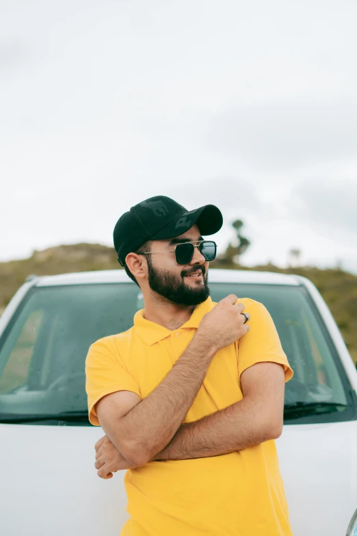 man wearing glasses standing by a car