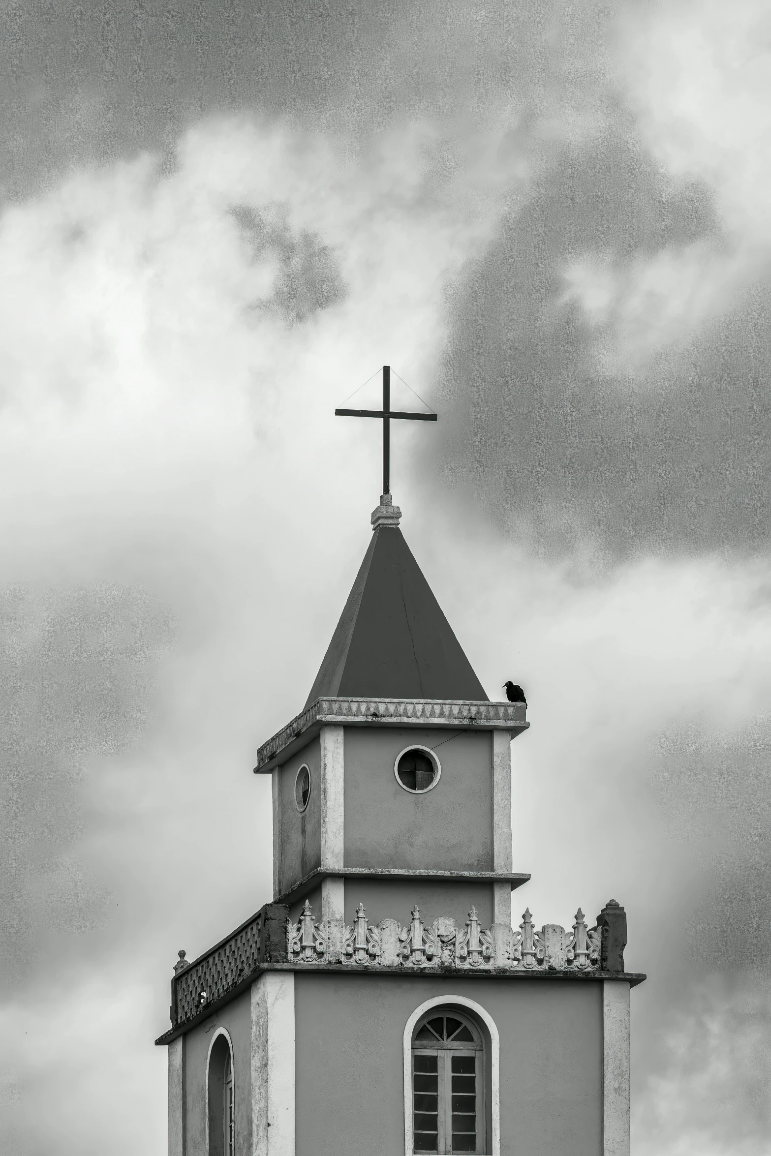 a small white church steeple with a cross on top