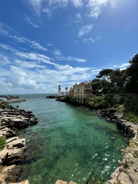 the shore of a sea cliff with houses on it