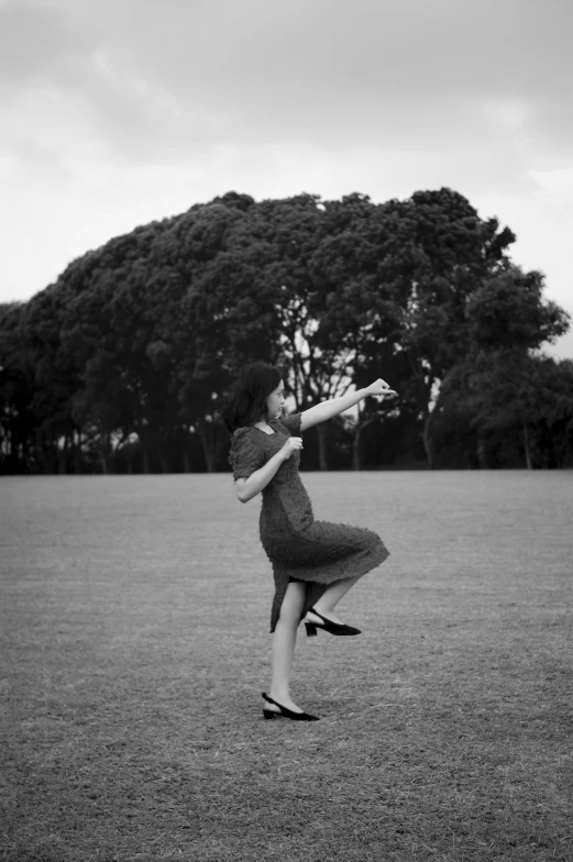 a girl is catching a frisbee on the field