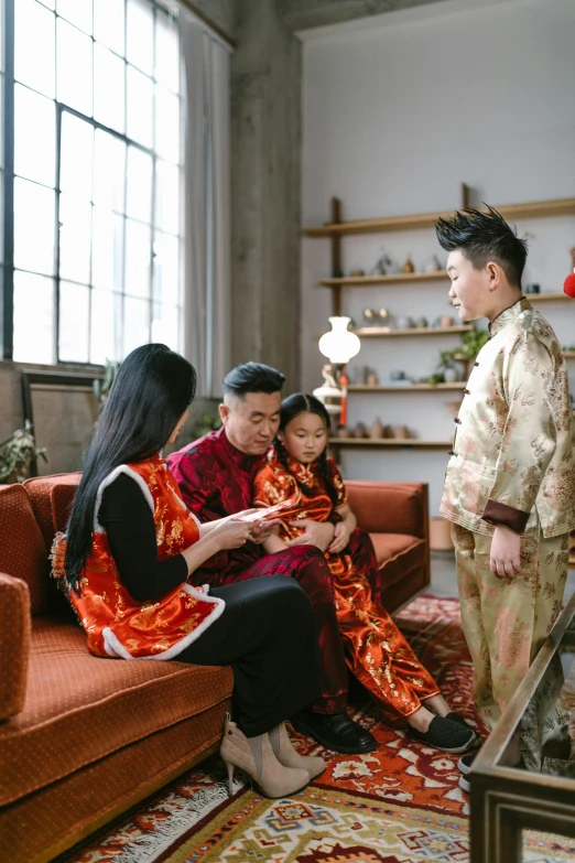 two women and one man are dressed in asian clothes