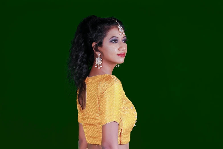 a woman standing in front of a green screen