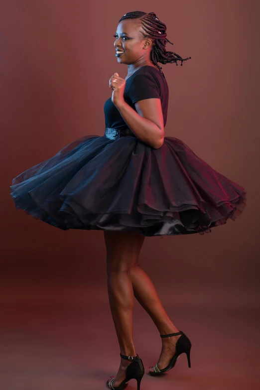 young black girl with black heels in a purple and black dress