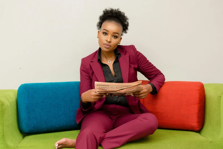 a woman sitting on top of a colorful couch