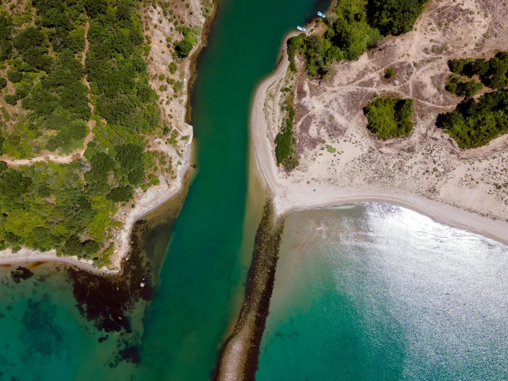 an aerial s shows the water in an area with white sand and green trees