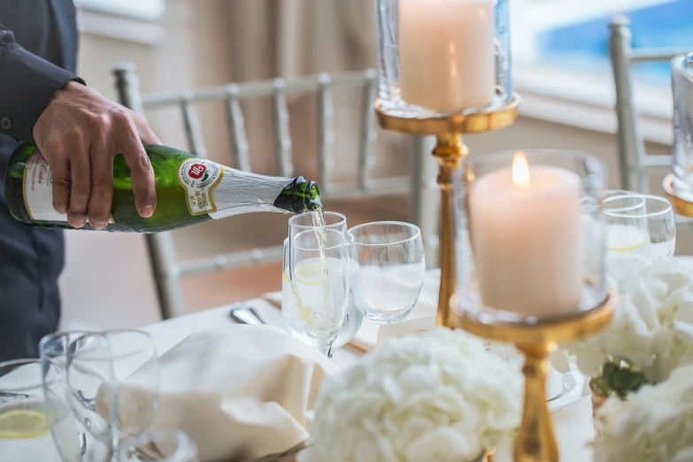 a bottle of champagne being poured into a champagne goblet