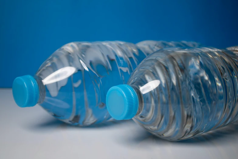 a close up of a two bottled water bottles