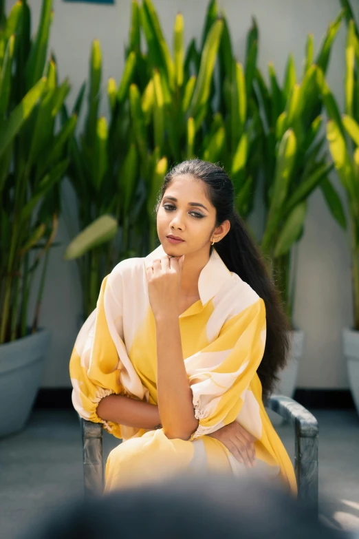 a woman is sitting on a bench posing