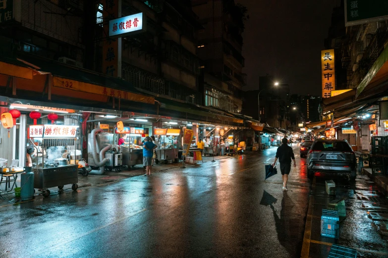 a rain soaked street at night on a rainy day