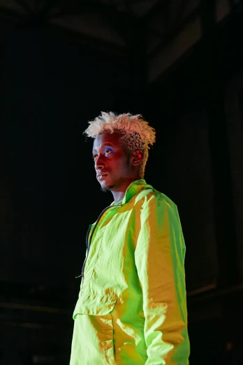 a man wearing neon jacket standing in the dark