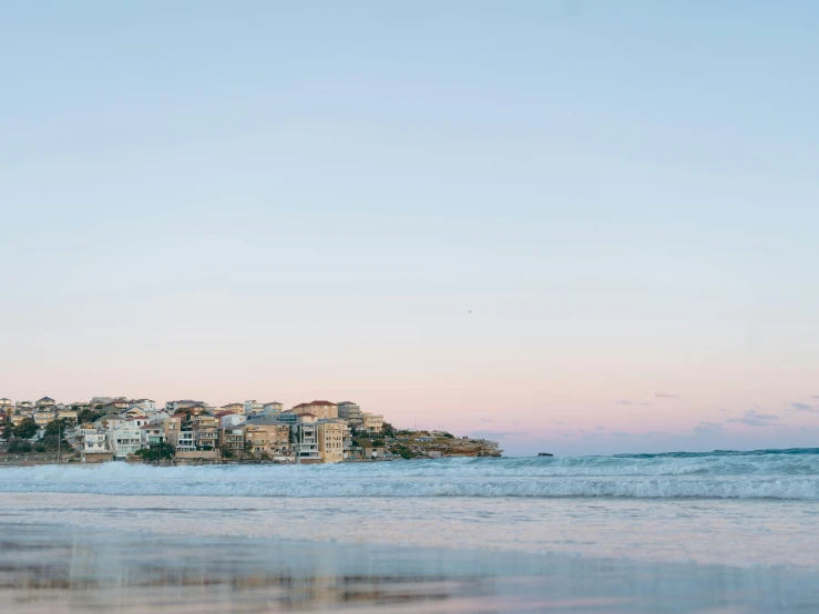 some water buildings and blue sky and some waves