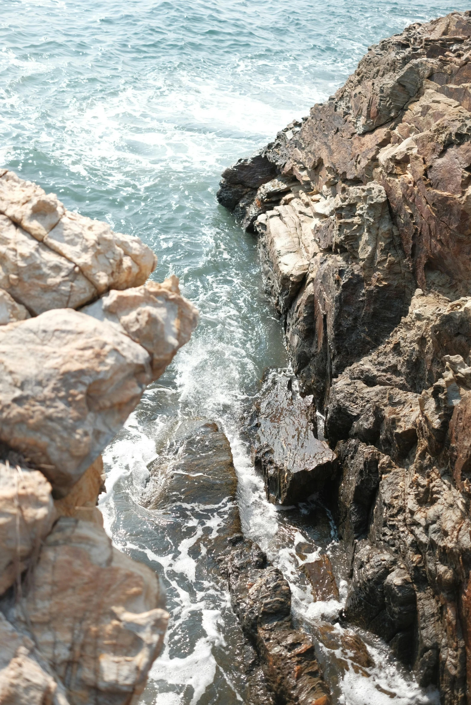 a close up of the water near rocky coastline