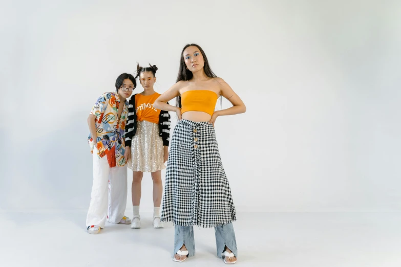 three ladies stand next to each other and look down at the camera