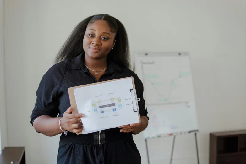 a woman holding up an unfinished laptop computer