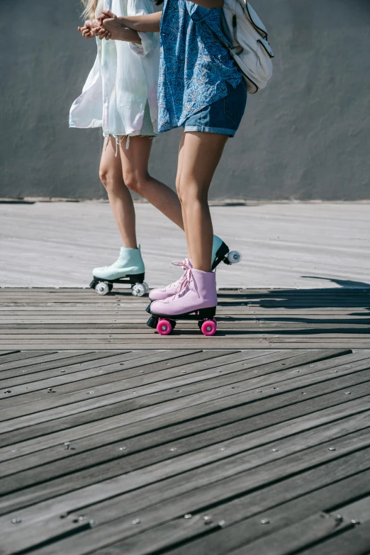 two people that are riding skateboards down the street