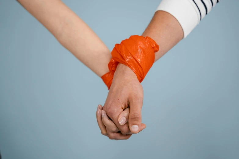 a close up of two people holding hands