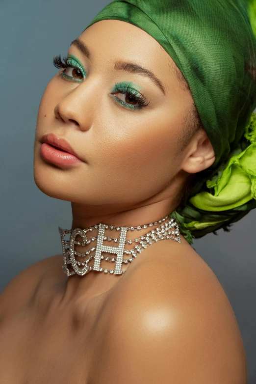 the young woman has green hair and a head wrap